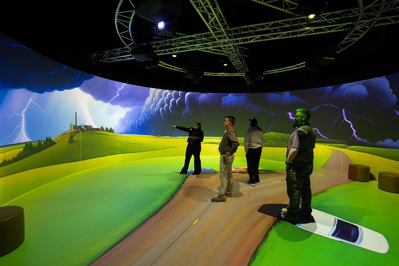 Storm Cylinder People stood in a VR cylinder looking at a projection of a storm